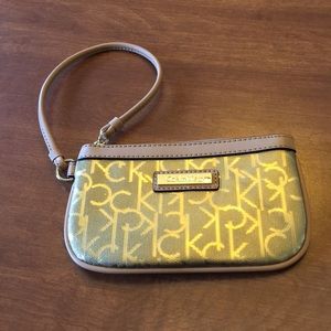 Calvin Klein gold wristlet with tan trim